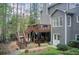 View of the home's back exterior featuring a deck, covered patio, and backyard at 201 Rippling Nw Dr, Marietta, GA 30064