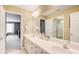 Bright bathroom featuring double sinks, a large mirror, and access to a separate shower and toilet room at 201 Rippling Nw Dr, Marietta, GA 30064