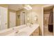 Bright bathroom featuring double sinks, a large mirror, and access to a shower and toilet room at 201 Rippling Nw Dr, Marietta, GA 30064