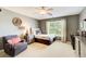 A calming bedroom with a ceiling fan, a large window, and cozy decor at 201 Rippling Nw Dr, Marietta, GA 30064
