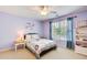 A light-purple bedroom offers a cozy bed and bedside tables near the bright window at 201 Rippling Nw Dr, Marietta, GA 30064
