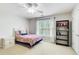 Bright bedroom featuring a plaid bedspread, large window and black bookshelf with a playful decor at 201 Rippling Nw Dr, Marietta, GA 30064