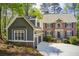Lovely two-story house featuring a brick facade and a well-manicured front yard surrounded by lush greenery at 201 Rippling Nw Dr, Marietta, GA 30064