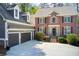 Charming brick two-story home featuring a two-car garage, black shutters and well-manicured landscaping at 201 Rippling Nw Dr, Marietta, GA 30064
