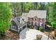 Charming two-story home featuring a brick facade and a well-manicured front yard surrounded by mature trees at 201 Rippling Nw Dr, Marietta, GA 30064