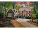 Beautiful home showcasing neutral siding, a brick facade, black shutters, and a spacious driveway at 201 Rippling Nw Dr, Marietta, GA 30064