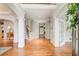Bright foyer featuring hardwood floors, white pillars, and a staircase, creating an elegant and welcoming entrance at 201 Rippling Nw Dr, Marietta, GA 30064