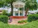 Charming gazebo in a park-like setting, surrounded by lush greenery and brick paving at 201 Rippling Nw Dr, Marietta, GA 30064