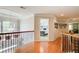 Hallway with hardwood floors, wooden and metal banisters, and neutral walls at 201 Rippling Nw Dr, Marietta, GA 30064