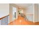 Long hallway with hardwood flooring, neutral-colored walls, and staircase at 201 Rippling Nw Dr, Marietta, GA 30064