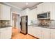 Bright kitchen with stainless steel appliances, tile backsplash, and ample cabinet space at 201 Rippling Nw Dr, Marietta, GA 30064
