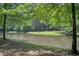 Scenic lake view surrounded by lush trees and grassy areas, perfect for relaxation at 201 Rippling Nw Dr, Marietta, GA 30064
