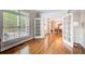 Bright living room featuring hardwood floors, large windows, and French doors leading to a dining area at 201 Rippling Nw Dr, Marietta, GA 30064