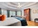Bright bedroom with a tray ceiling, hardwood floors, and multiple windows offering natural light at 201 Rippling Nw Dr, Marietta, GA 30064