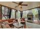 Screened-in patio with brick fireplace, comfortable seating, and a ceiling fan for relaxing outdoors at 201 Rippling Nw Dr, Marietta, GA 30064