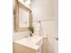 Charming powder room with a farmhouse mirror and white wainscoting at 201 Rippling Nw Dr, Marietta, GA 30064