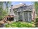 Back of house showing deck, patio, well-maintained lawn, and mature trees at 201 Rippling Nw Dr, Marietta, GA 30064