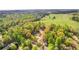 Scenic aerial view of wooded property near a lush green field at 530 S Lost Lake Cv, Villa Rica, GA 30180