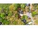 Aerial view of a wooded property with home, driveway, and surrounding greenery at 530 S Lost Lake Cv, Villa Rica, GA 30180