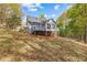 Elevated view of backyard with deck, partial sunroom, and a wooded property line at 530 S Lost Lake Cv, Villa Rica, GA 30180