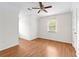 Bright bedroom with wood-look floors and a ceiling fan, creating a welcoming atmosphere at 530 S Lost Lake Cv, Villa Rica, GA 30180