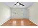 Bright bedroom with hardwood floors, ceiling fan, and natural light from two windows at 530 S Lost Lake Cv, Villa Rica, GA 30180