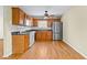 Well-lit kitchen with stainless steel appliances, wood cabinets and hardwood floors at 530 S Lost Lake Cv, Villa Rica, GA 30180