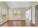 Bright, airy living room features wood-look flooring and multiple windows offering natural light at 530 S Lost Lake Cv, Villa Rica, GA 30180
