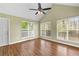 Bright living room with vaulted ceiling, multiple windows, and hardwood floors at 530 S Lost Lake Cv, Villa Rica, GA 30180