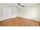 Bright main bedroom features hardwood floors, a ceiling fan, and a double door closet at 530 S Lost Lake Cv, Villa Rica, GA 30180
