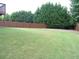Expansive backyard with lush green grass and a wooden privacy fence at 5610 Hollowbrooke Ln, Acworth, GA 30101