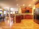 Open kitchen with wood cabinets, granite countertops, and hardwood flooring at 5610 Hollowbrooke Ln, Acworth, GA 30101