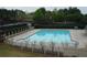 Large outdoor swimming pool with tennis courts in the background, great for recreation at 5610 Hollowbrooke Ln, Acworth, GA 30101