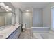 This spacious bathroom offers double sinks, a shower, a soaking tub, and a window at 6040 Carriage Dr, Cumming, GA 30028