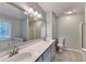 This primary bathroom boasts double sinks, a large mirror, a shower, a tub, and natural light from the window at 6040 Carriage Dr, Cumming, GA 30028