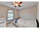 This cozy bedroom offers a window, a crib, a bed, and neutral walls at 6040 Carriage Dr, Cumming, GA 30028