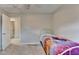 This neutral bedroom has a ceiling fan and carpeted floors at 6040 Carriage Dr, Cumming, GA 30028