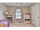 This bedroom offers a ceiling fan, a bed, a window, and storage cabinets at 6040 Carriage Dr, Cumming, GA 30028