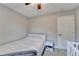 Bright bedroom features neutral walls, ceiling fan, and a well-placed nightstand at 6040 Carriage Dr, Cumming, GA 30028