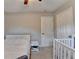 Bright bedroom features neutral walls, ceiling fan, and a well-placed nightstand at 6040 Carriage Dr, Cumming, GA 30028