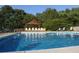 Sparkling community pool with ample seating and a shaded gazebo at 6040 Carriage Dr, Cumming, GA 30028
