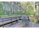Outdoor deck features a charming bench and outdoor seating area with backyard views at 6040 Carriage Dr, Cumming, GA 30028