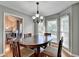 Cozy dining room featuring wood floors, round table, chandelier and large windows at 6040 Carriage Dr, Cumming, GA 30028