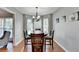 Dining room with wood table and chairs, large windows, and hardwood floors at 6040 Carriage Dr, Cumming, GA 30028