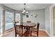 Charming dining room with bay window, wooden table, and gray walls at 6040 Carriage Dr, Cumming, GA 30028