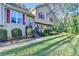 Charming two-story home with red shutters, a lush lawn, and mature landscaping offering great curb appeal at 6040 Carriage Dr, Cumming, GA 30028