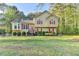 Charming two-story home with a well-maintained lawn, red shutters, and a welcoming front entrance at 6040 Carriage Dr, Cumming, GA 30028