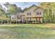 Charming two-story home with a well-maintained lawn, red shutters, and a welcoming front entrance at 6040 Carriage Dr, Cumming, GA 30028