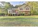 Charming two-story home with a well-maintained lawn, red shutters, and a welcoming front entrance at 6040 Carriage Dr, Cumming, GA 30028