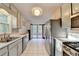 Spacious kitchen featuring stainless steel appliances, white cabinets, and access to the deck at 6040 Carriage Dr, Cumming, GA 30028